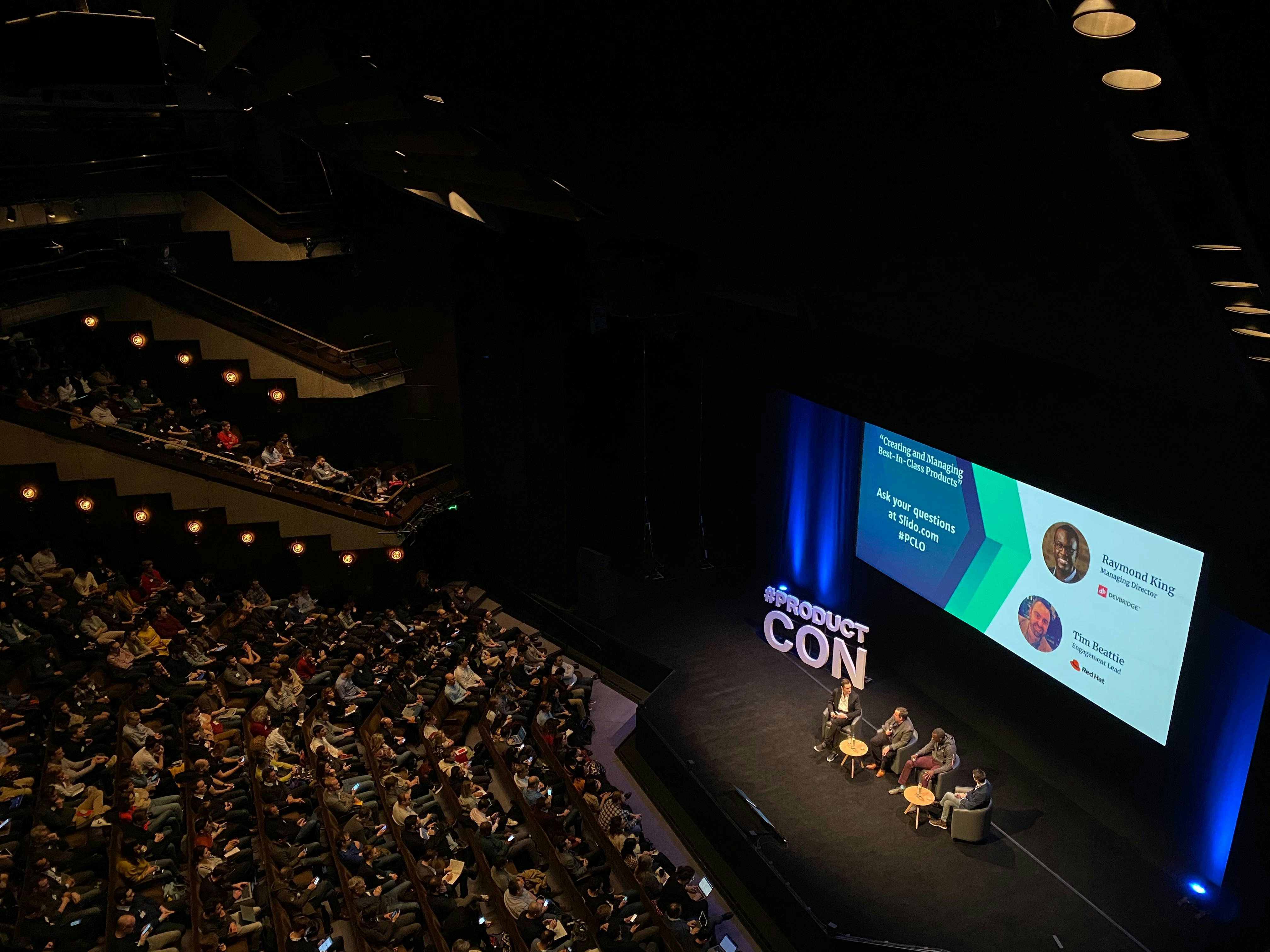 Panel discussion on stage at a ConnectX conference